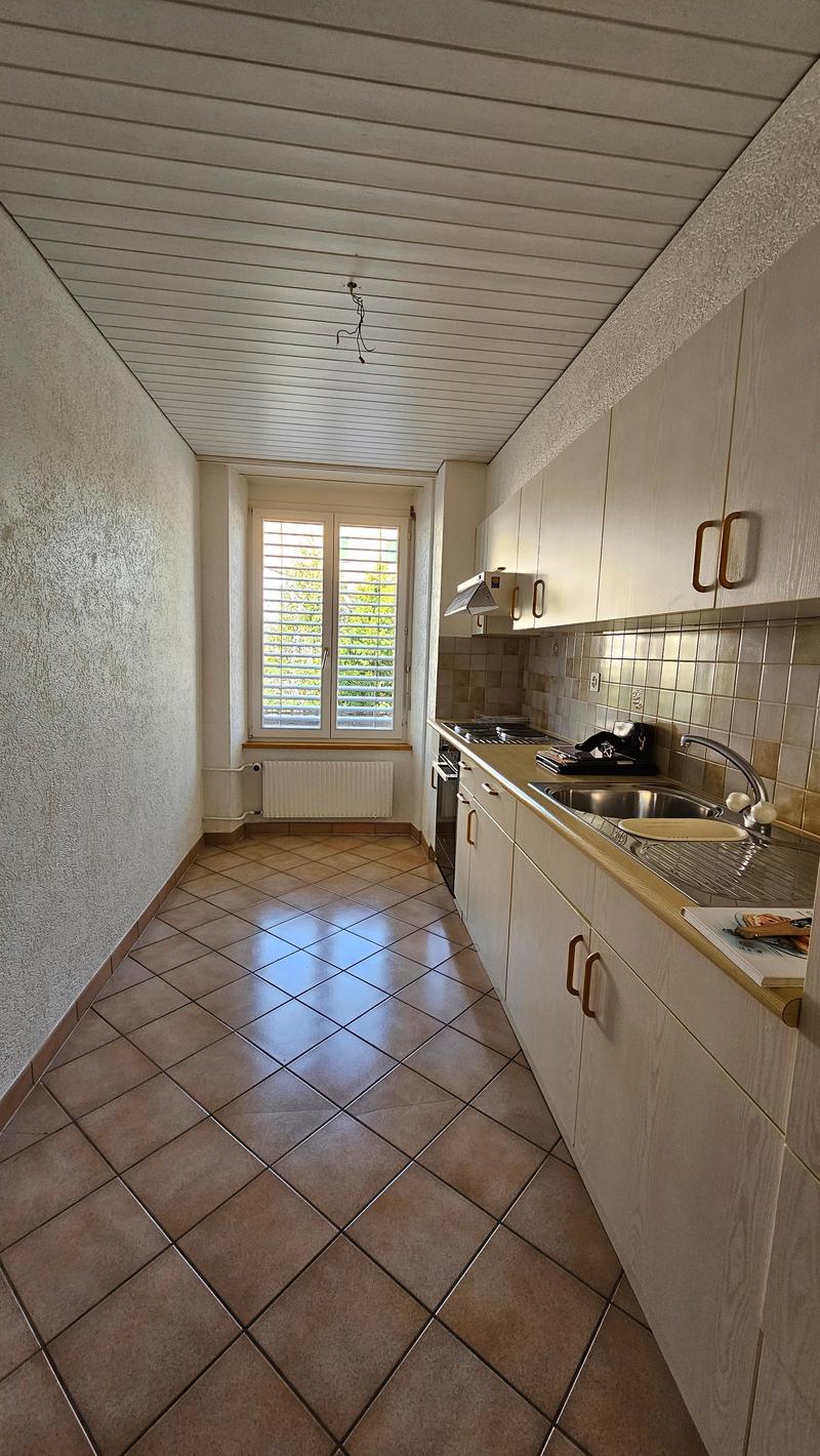 modern design, tiled floor, white cabinets, stainless steel sink, window with blinds