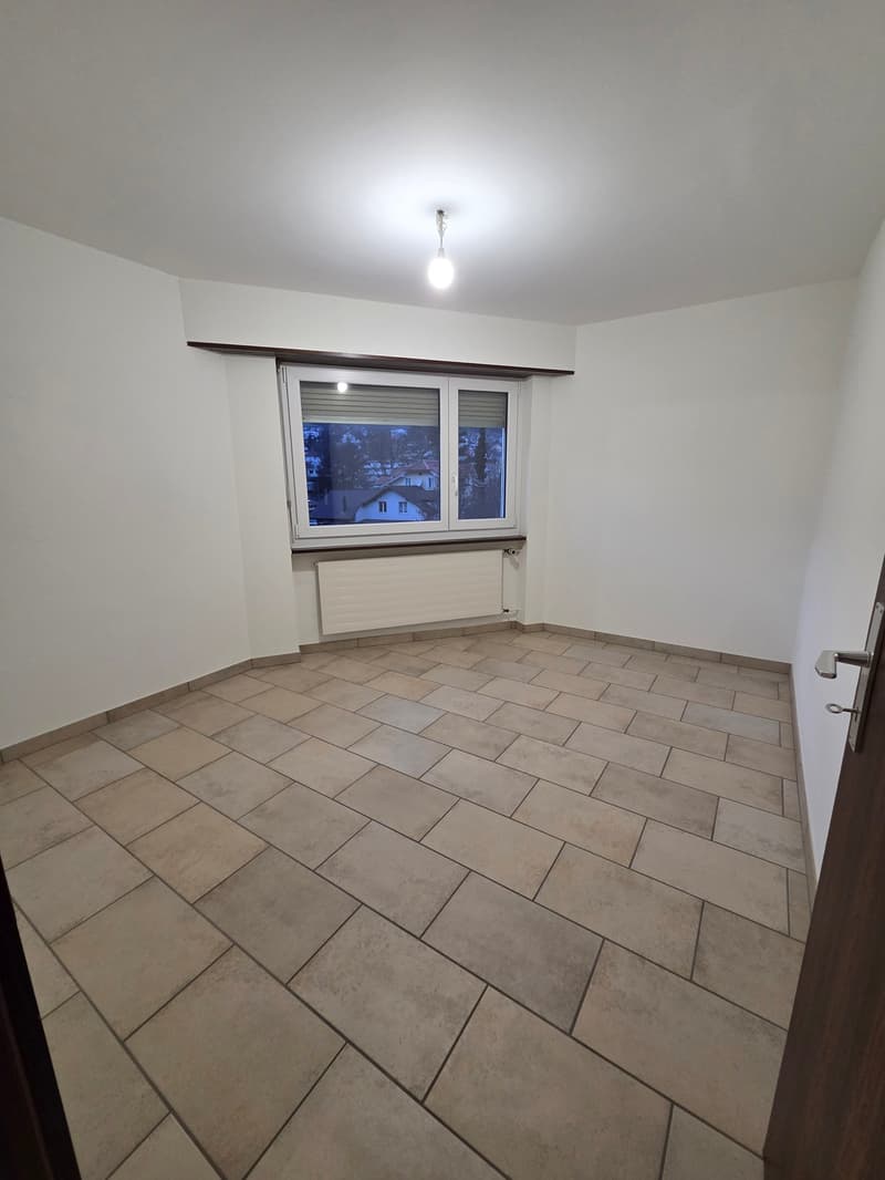empty room, white walls, tiled floor, window with blinds, radiator