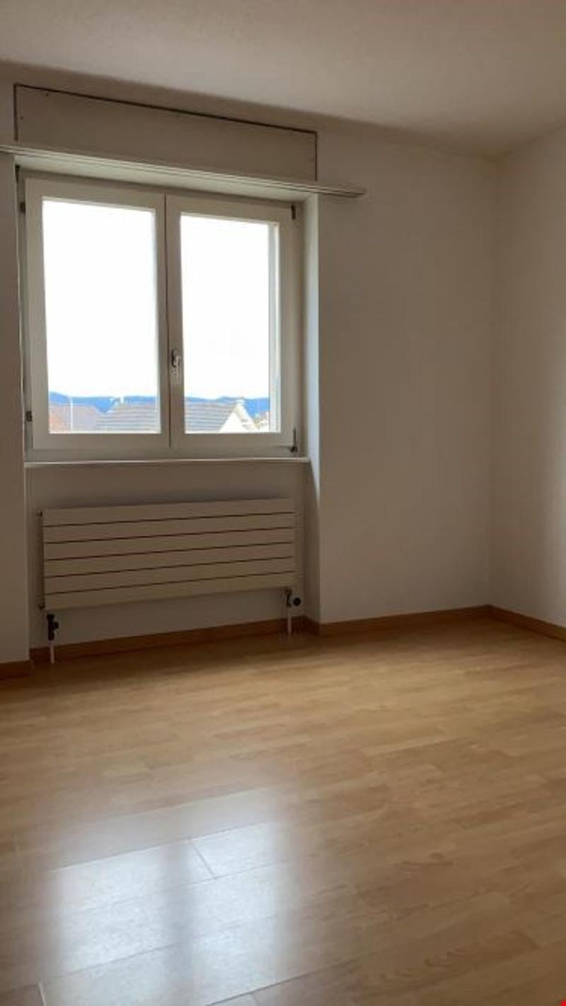 empty room, white walls, large window, wooden floor, window view to the outside