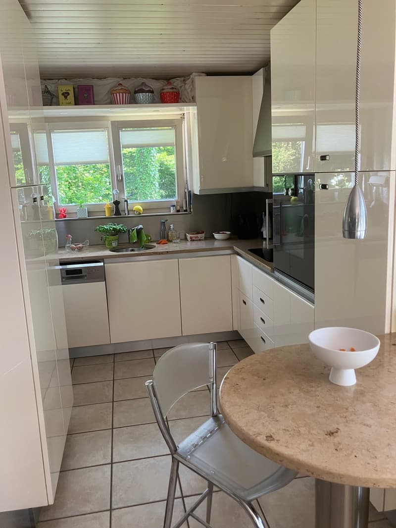 modern clean kitchen, white cabinets, granite countertop, integrated appliances, sink with faucet