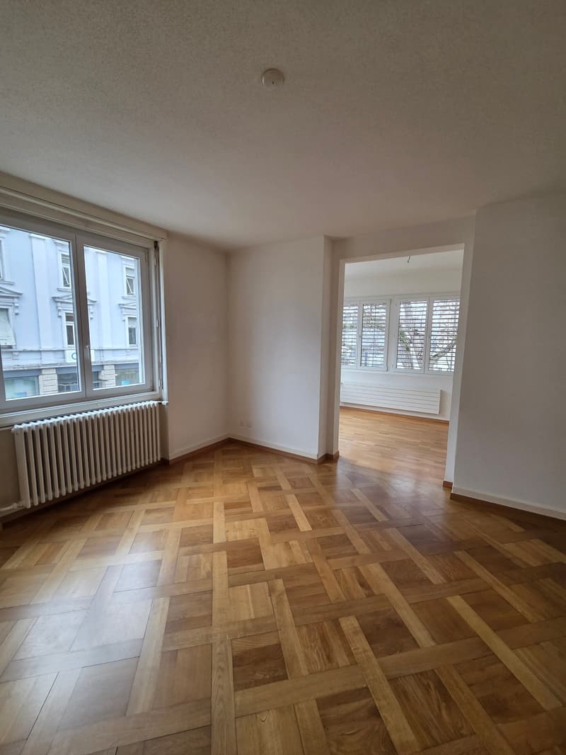 empty room, hardwood floor, windows, radiator, hallway