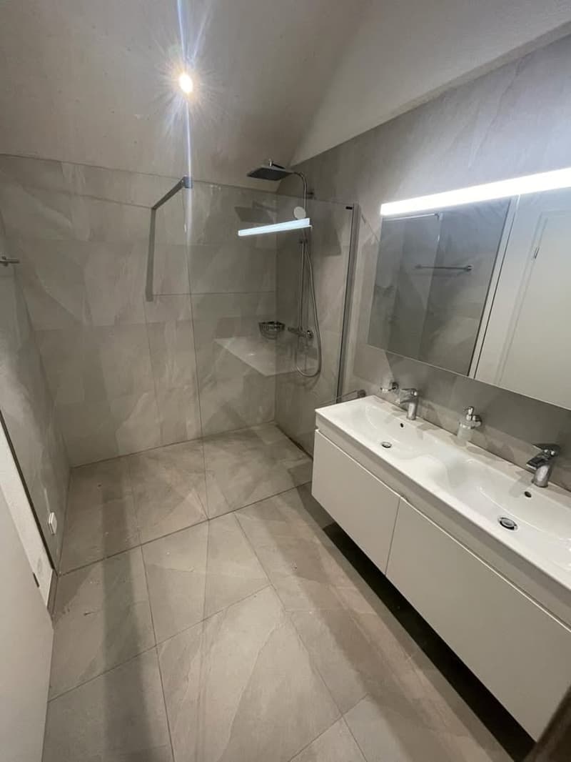 modern bathroom, double sink, separate shower stall, tiled flooring, mirror with light