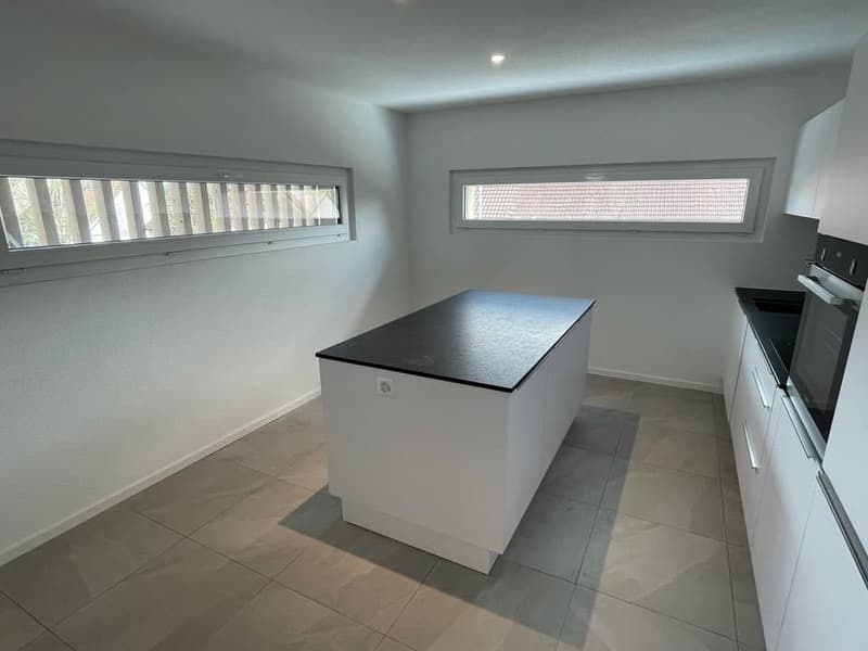 modern kitchen, island counter, white cabinets, tiled floor, windows, black countertop