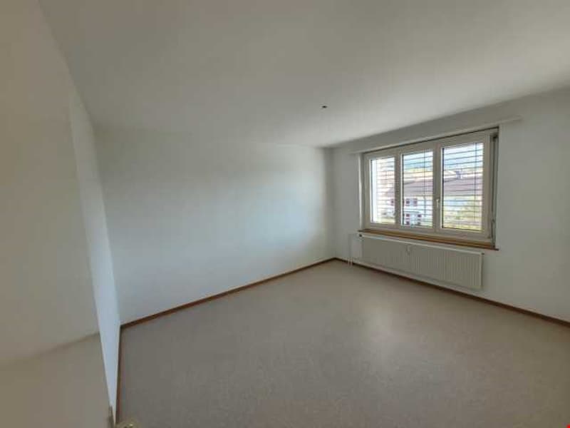 Empty room, white walls, white floor, window with shutters