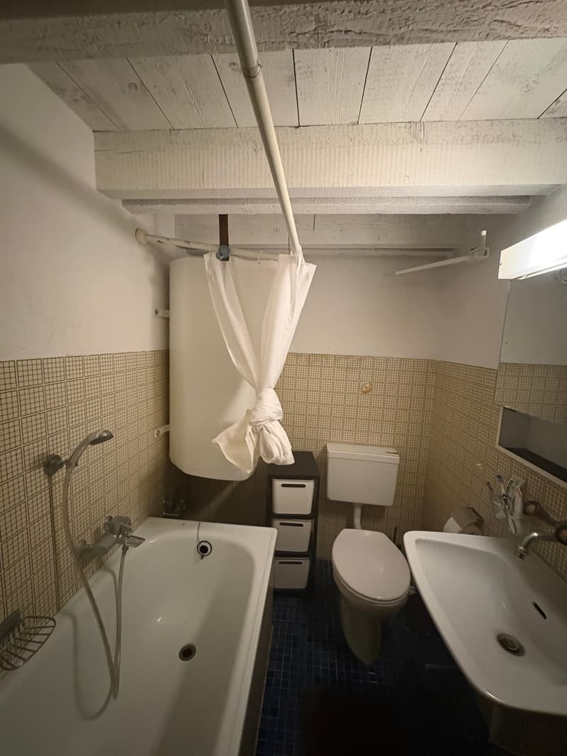 Bathroom with bathtub, toilet, sink, and storage drawers