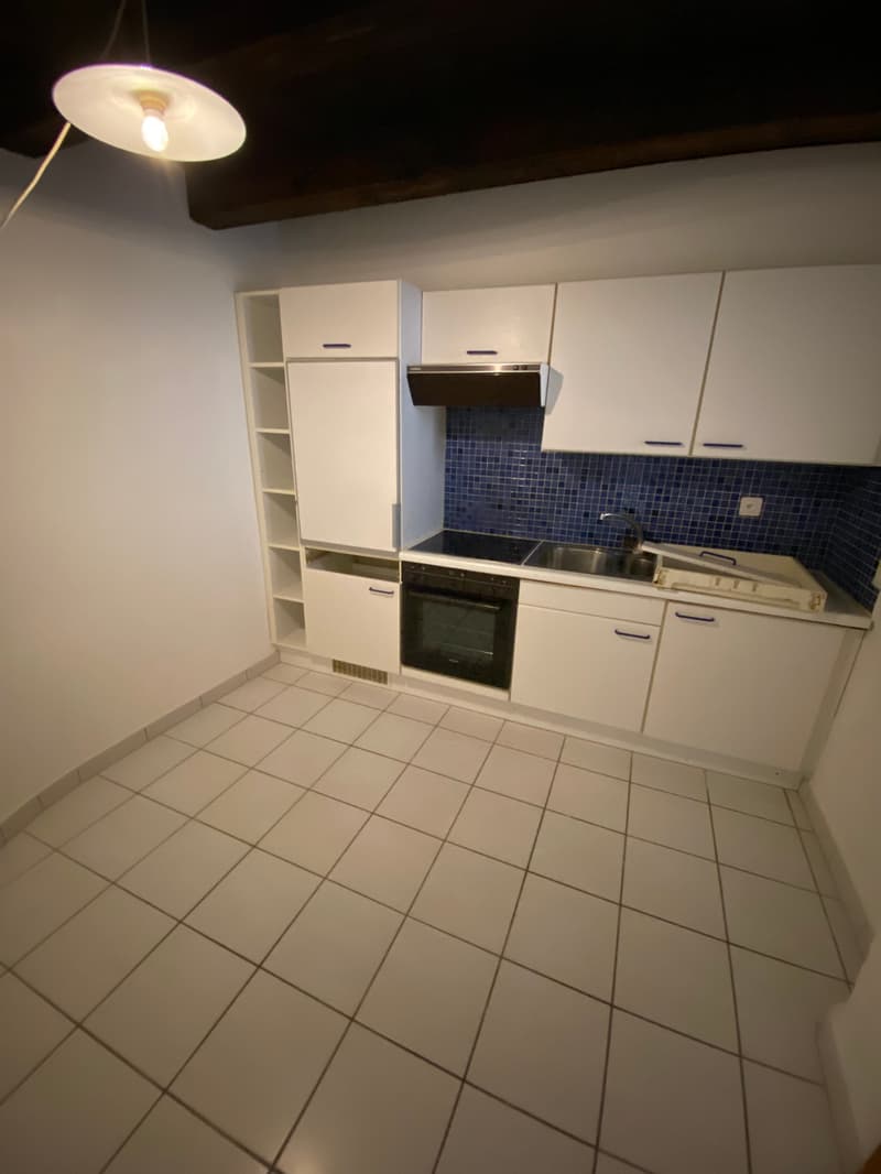 modern kitchen with white cabinets, blue tiles, electric stove, oven, sink, dishwasher, washing machine