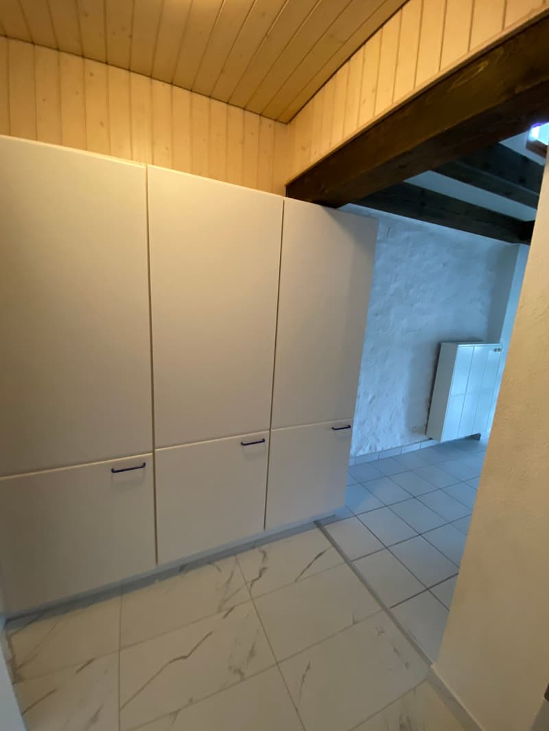 white cabinets, white tiled floor, wooden ceiling, white wall, small white cabinet