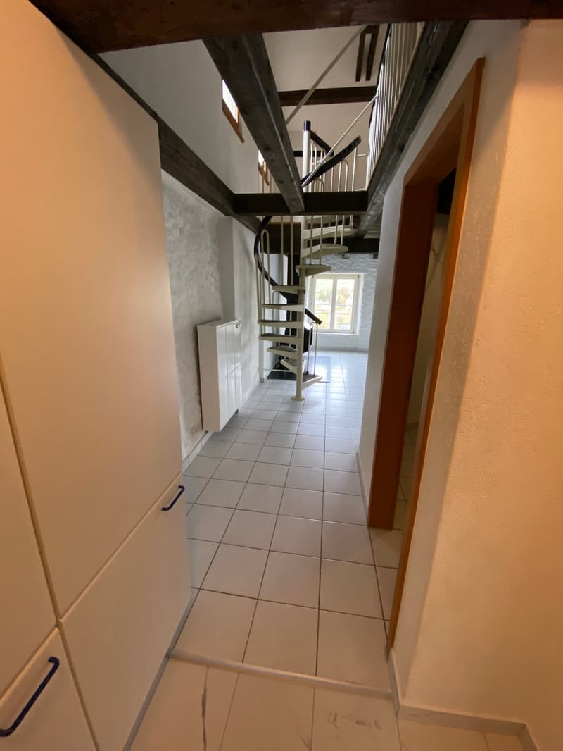 white tiled floor, spiral staircase, wooden beams, white cabinets, white walls