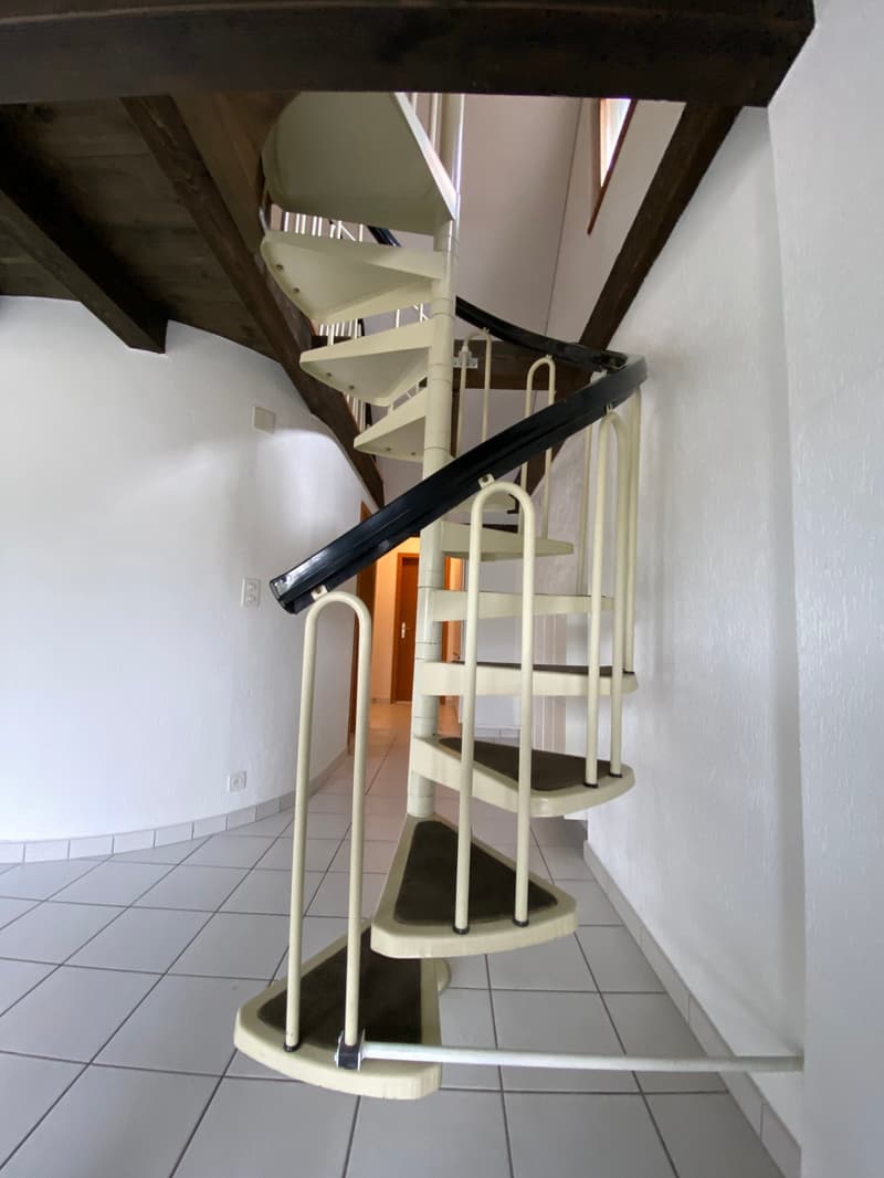 spiral staircase, white tiled floor, white walls, wooden ceiling