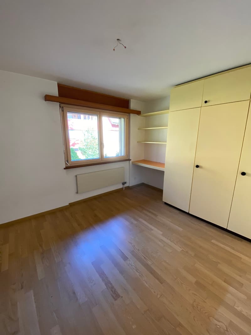 empty room, wooden floor, white walls, window, built-in wardrobe, shelves, radiator