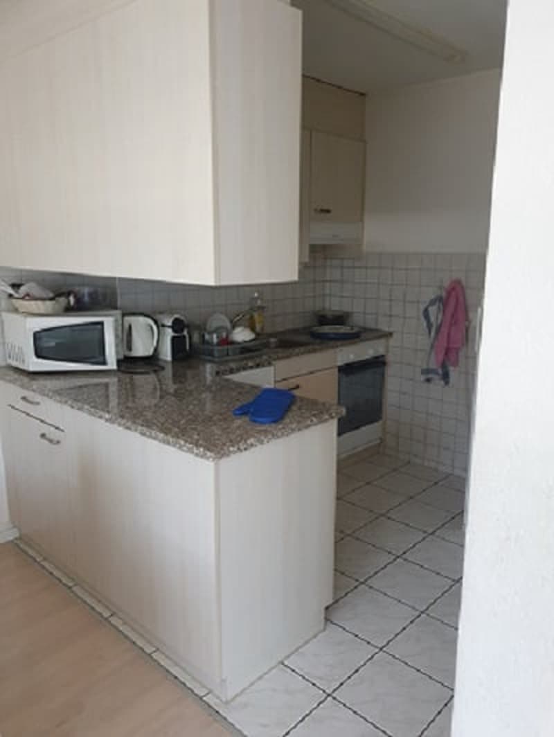 kitchen with white cabinets, granite countertop, white tiled floor, white microwave, white oven, white sink, white refrigerator
