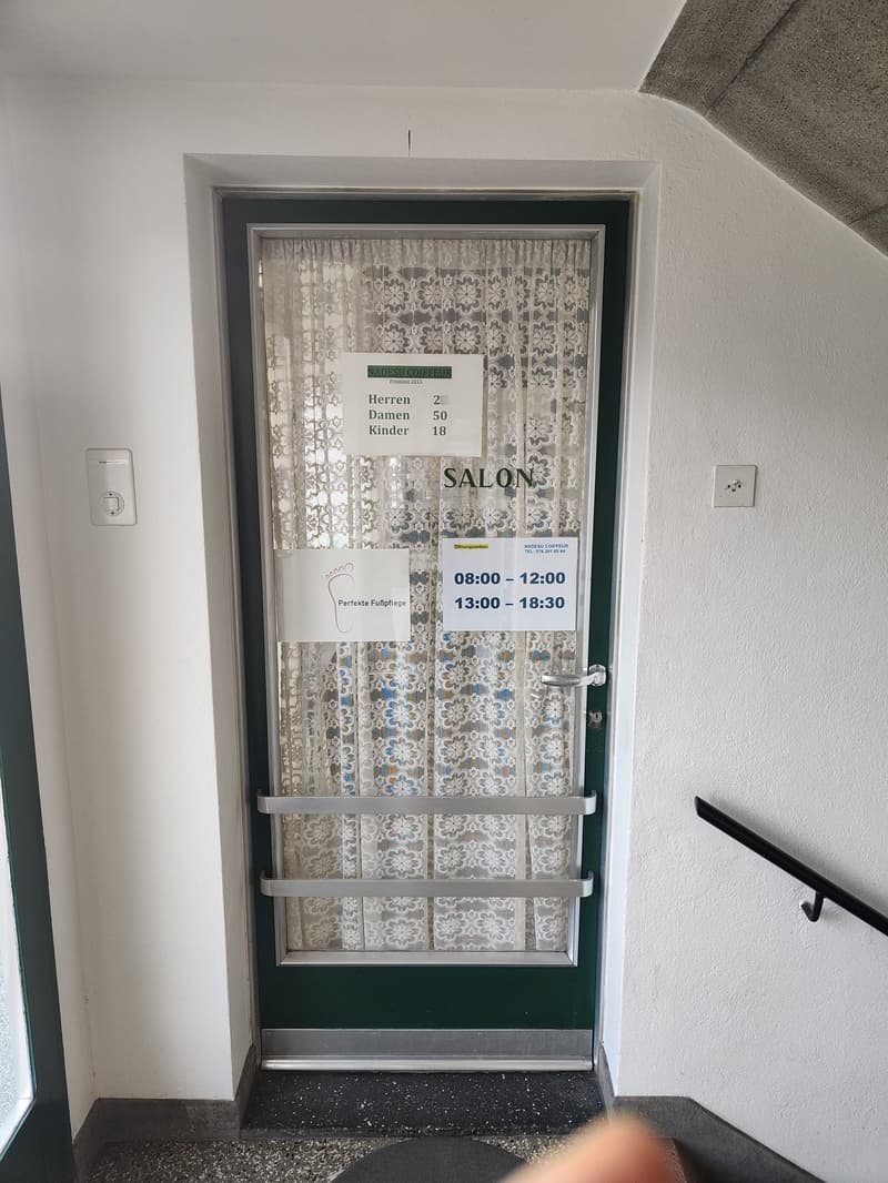 Green door, white curtain, salon sign