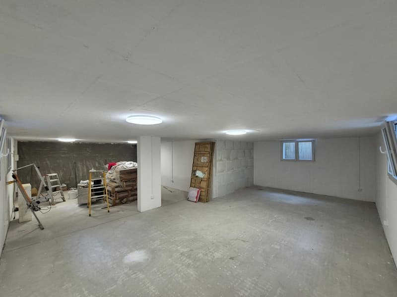 empty room with a ceiling and lights, a small white pillar, ladders and tools