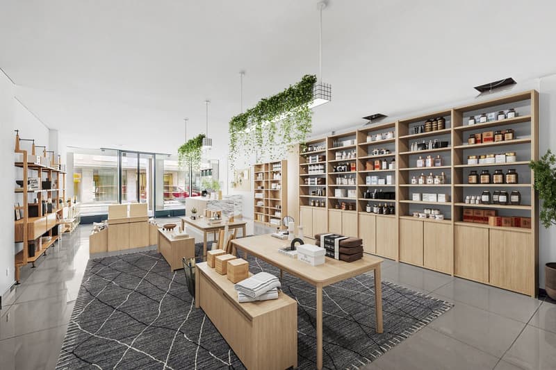 modern shop with open layout, wooden furniture, shelves, hanging plants, tiled floor, carpet, and tables with stacked towels