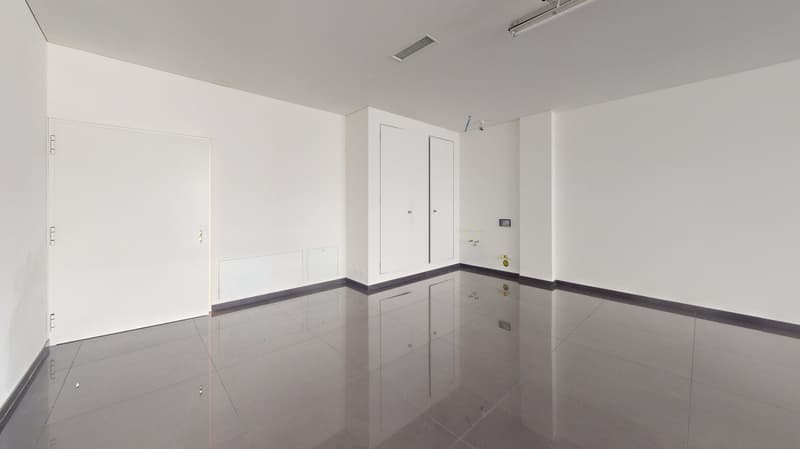 Empty room with white walls, tile flooring, and built-in cabinets. There appears to be a dishwasher installed in the room.