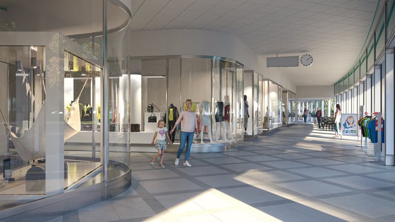 The image shows a modern shopping mall interior with glass storefronts, a long hallway with tiled flooring, and people walking through the space. There appears to be a balcony or terrace visible in the background.