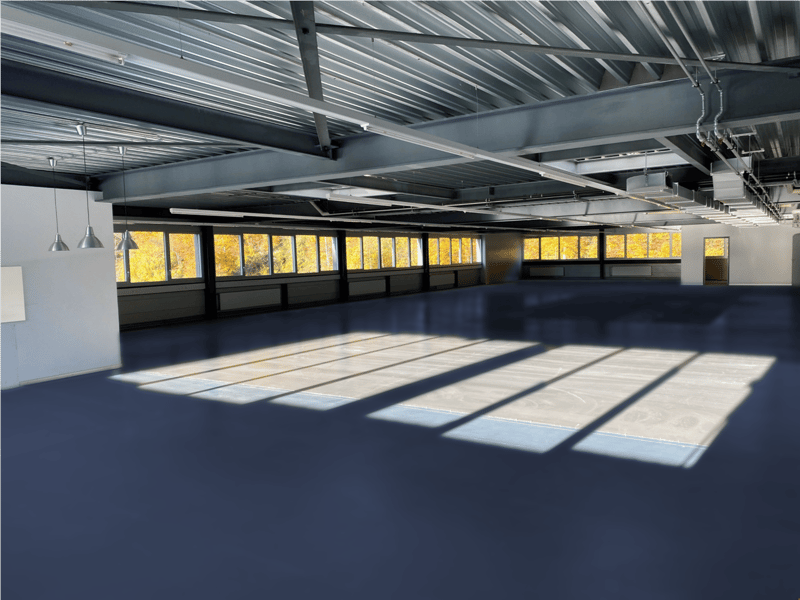 empty room, steel ceiling, blue floor, large windows, sunlight