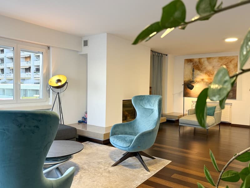 modern decor, fireplace, dark wood floors, large window, teal chairs, round coffee table, light fixture, painting, sofa, plants