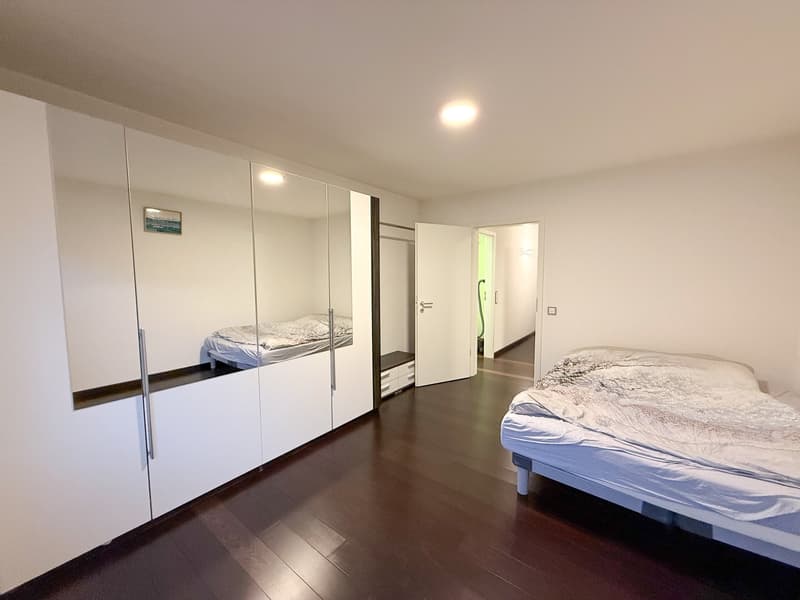 white wardrobes, wooden floor, bed, mirror