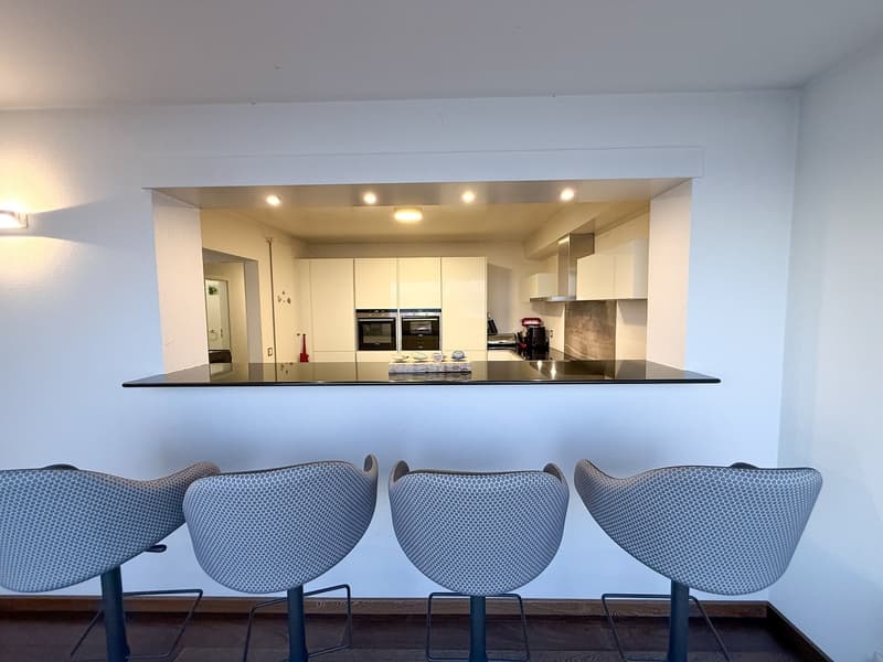 Modern kitchen, counter, white cabinets, granite countertops, kitchen appliances, stools