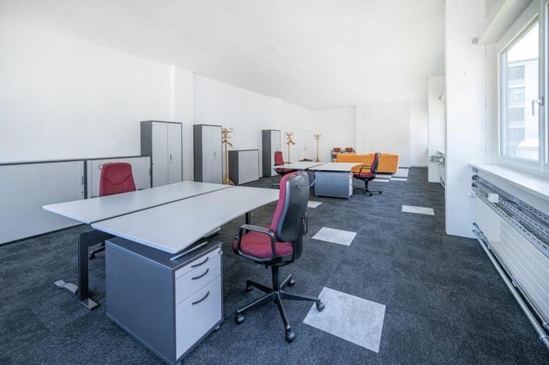 modern office room, gray desks, chairs, white walls, gray floor