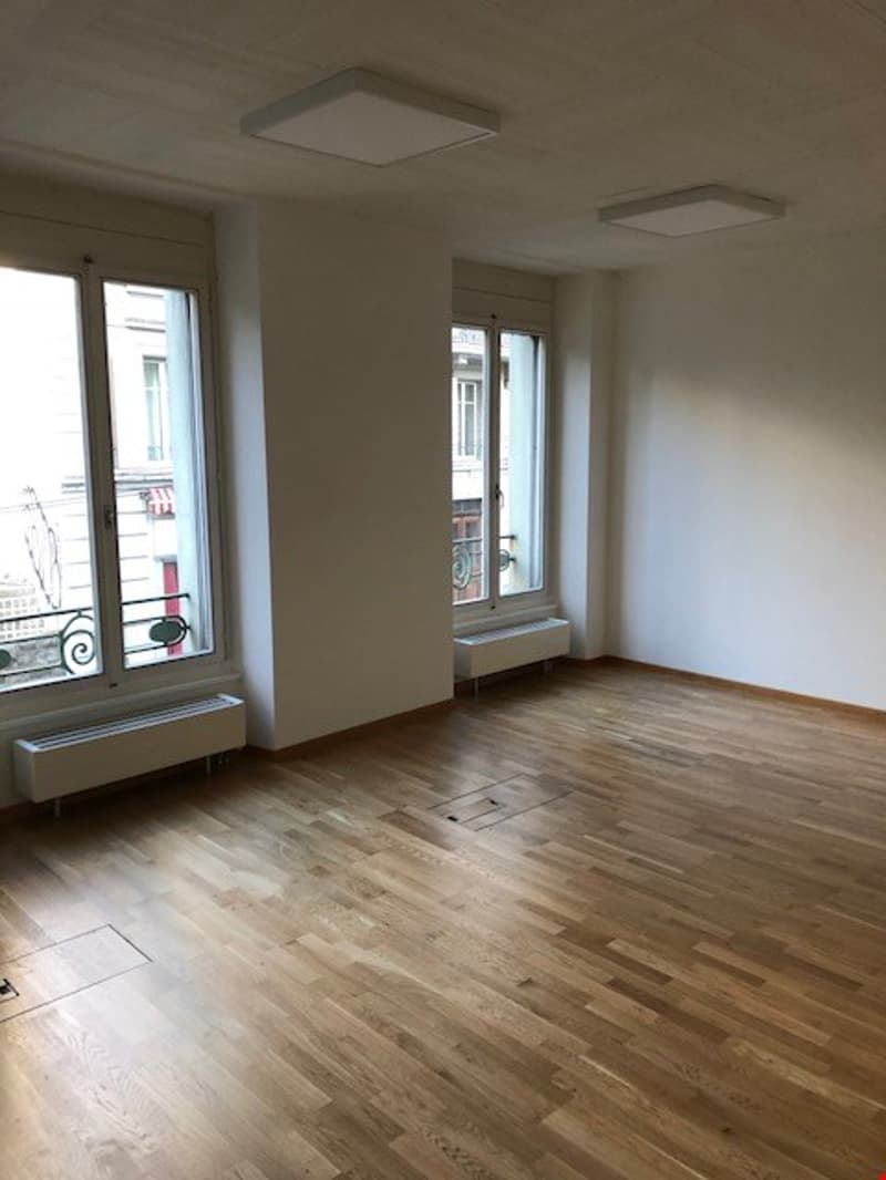 empty room, hardwood floors, windows, heating units