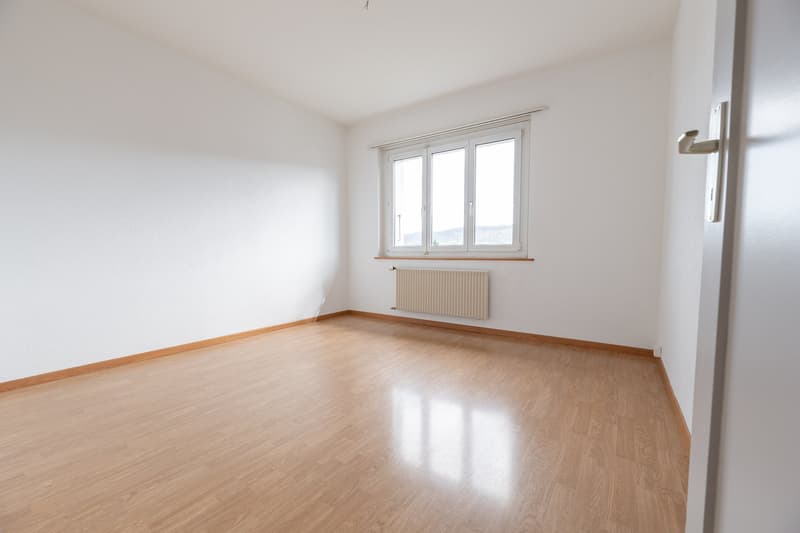 empty room, white walls, wooden floor, white window, white radiator