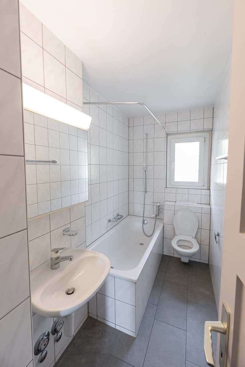 Bathroom, sink, toilet, bathtub, mirror, white tile, shower, silver faucet