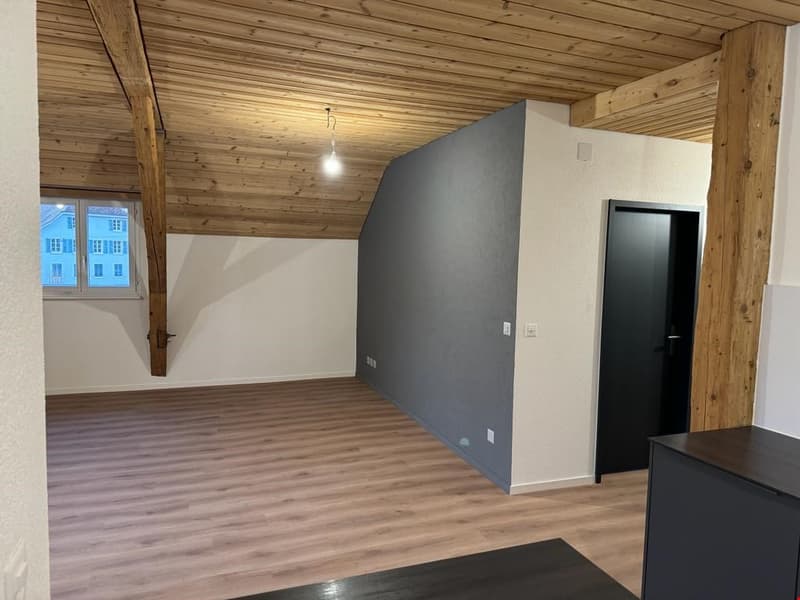 wooden ceiling, hardwood floor, gray wall, window, closed door, power outlets, wooden pillar