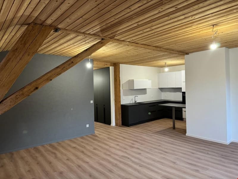 wooden ceiling, wooden floor, gray wall, black kitchen cabinets, granite countertop, undermount sink, faucet, open layout