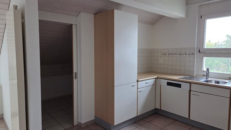 Compact kitchen with white cabinets, tile flooring, sink, dishwasher, gas stove