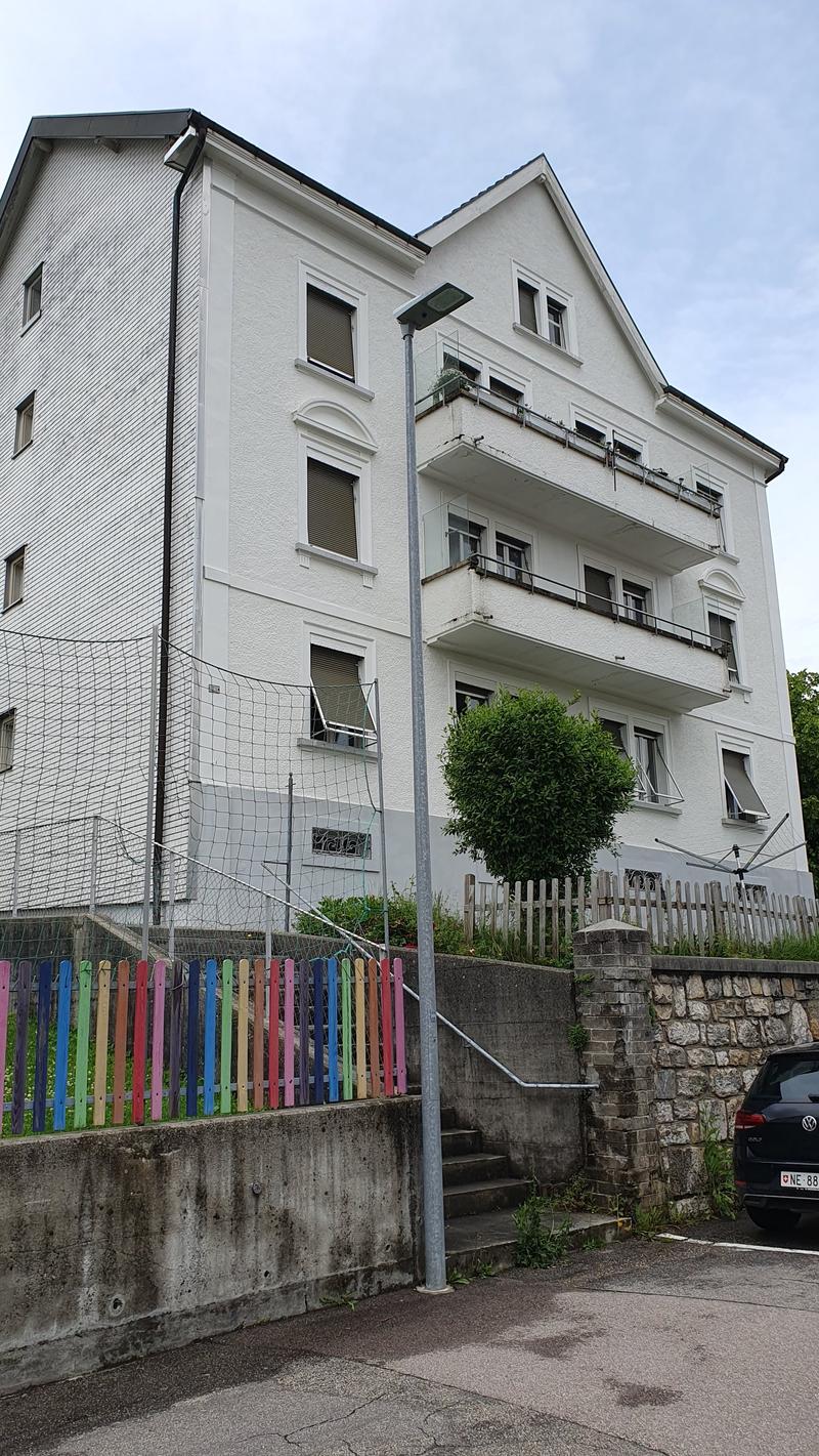 3 story house, brick walls, white windows, terraces, exterior stairs