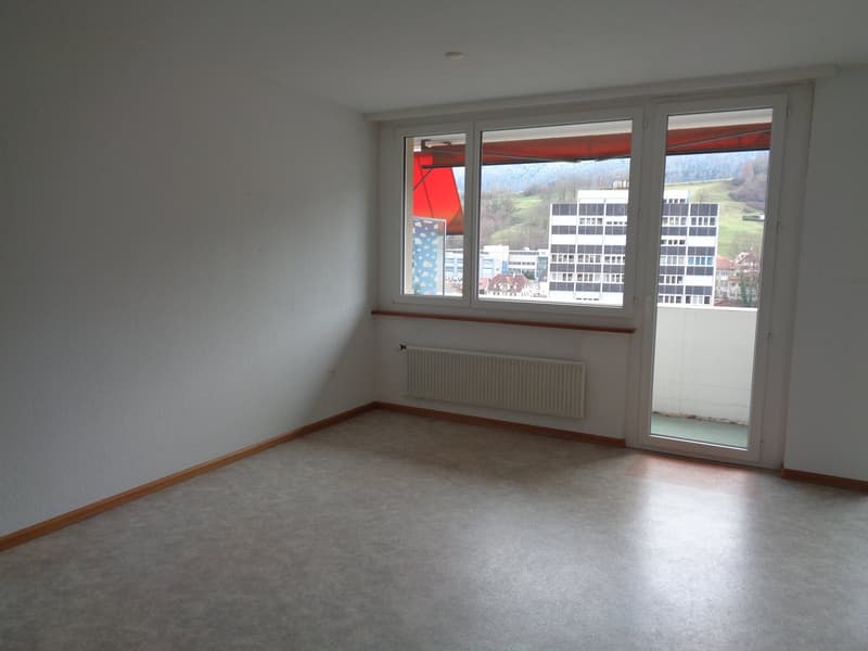 empty room, white walls, large windows, balcony, wooden floor, central heating