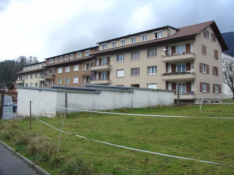 multi-family building, multiple balconies, ground floor, garden