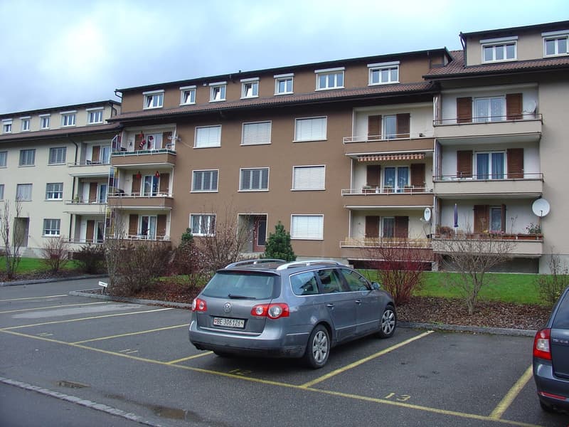 Apartment building, balconies, windows, parking lot