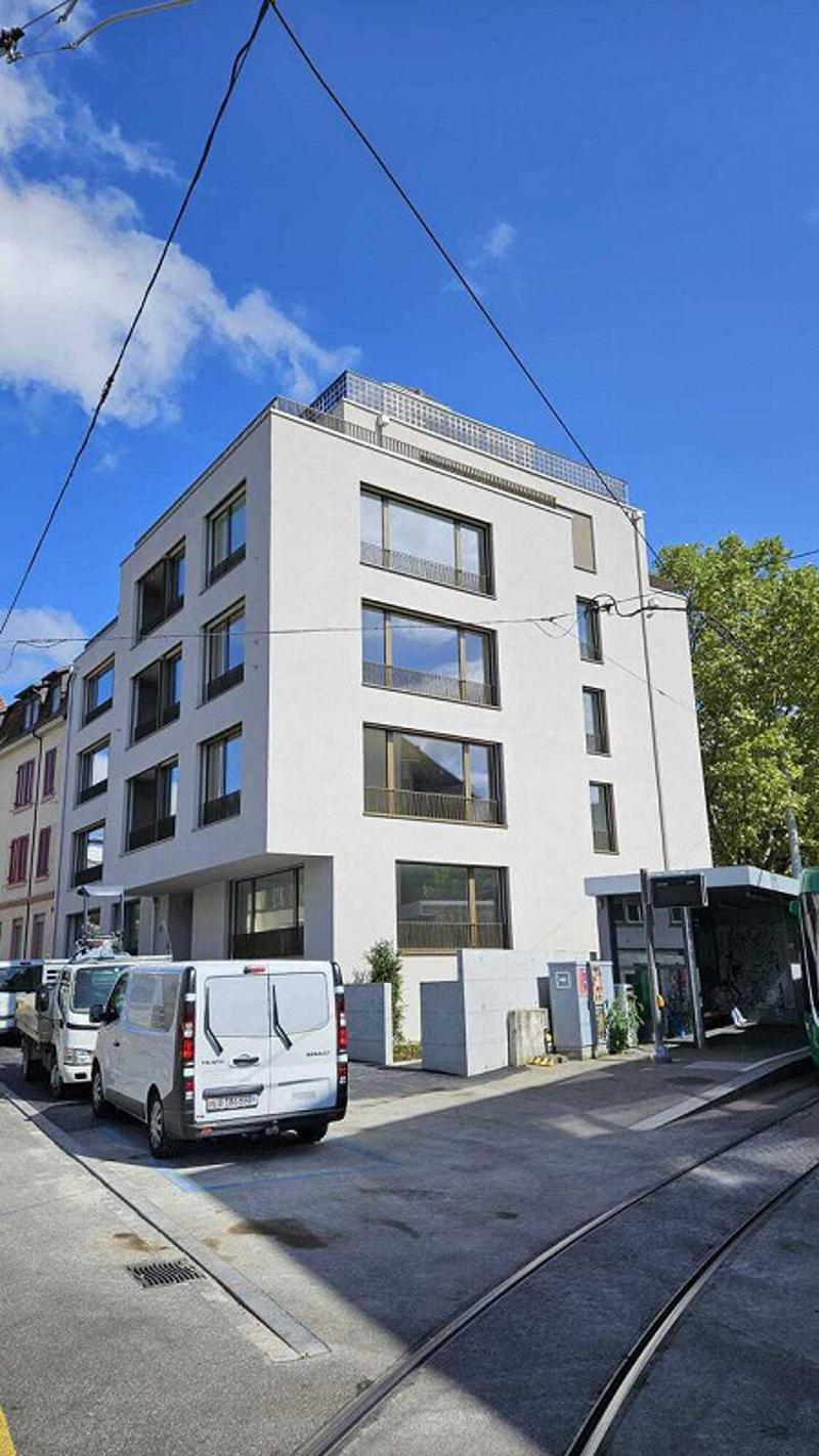 5 story white building, modern design, glass windows, balconies, modern architecture, public transport stop
