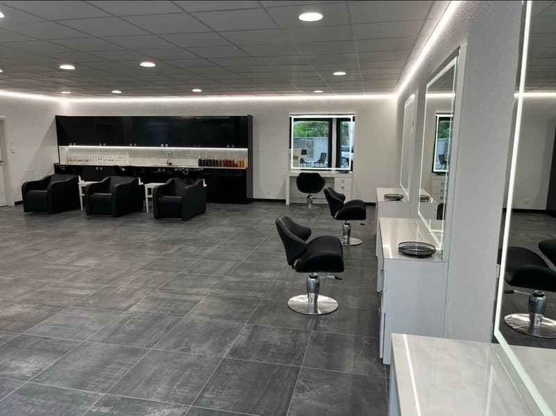 modern and clean salon with black seating and white countertops