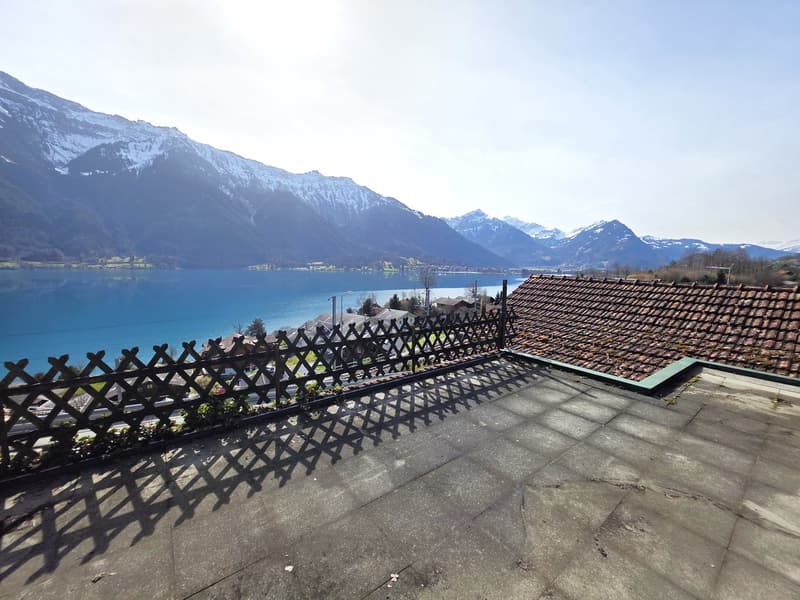 Roof terrace with a view of a lake and mountains