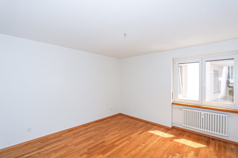 empty room, hardwood floor, white walls, large window, heater