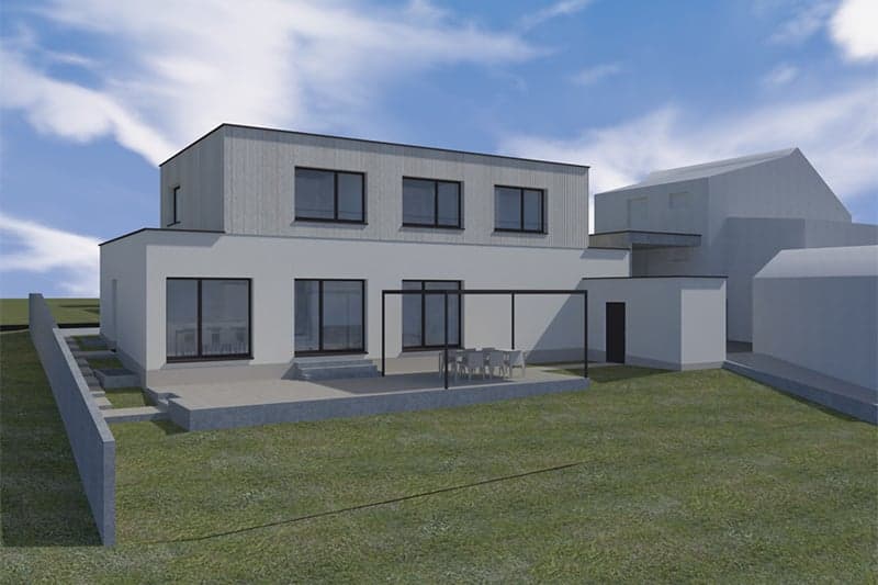 Two-story modern house with a flat roof, large windows, and a balcony or terrace on the second floor. The exterior is made of gray siding and the house is surrounded by a grassy lawn.