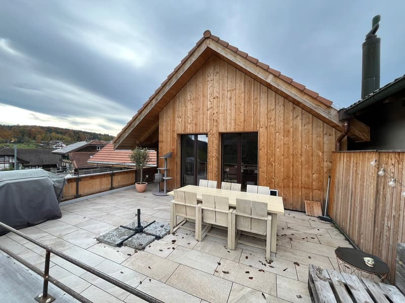 Wooden house, covered terrace, table and chairs, view of the valley
