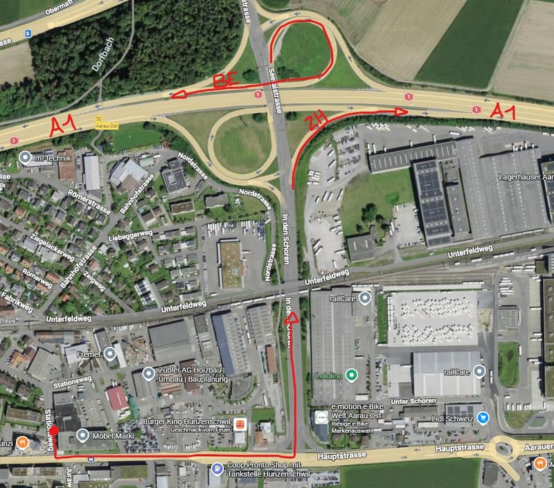 Aerial view of the area with multiple buildings, roads, and parking lots.