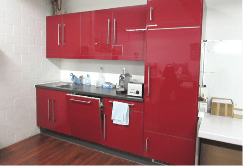 kitchen with red cabinets, sink, dishwasher, washing machine, wooden floor, tiled wall