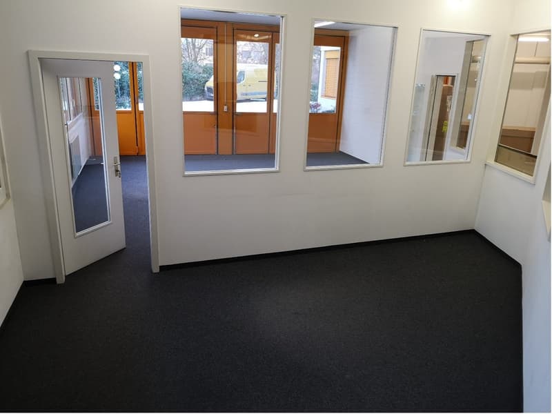 empty room, large windows, glass doors, white walls, black floor, plain interior