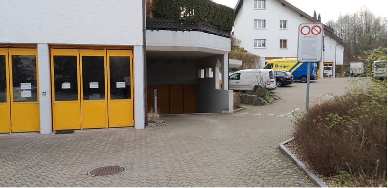 Apartment building with garage and parking entrance.