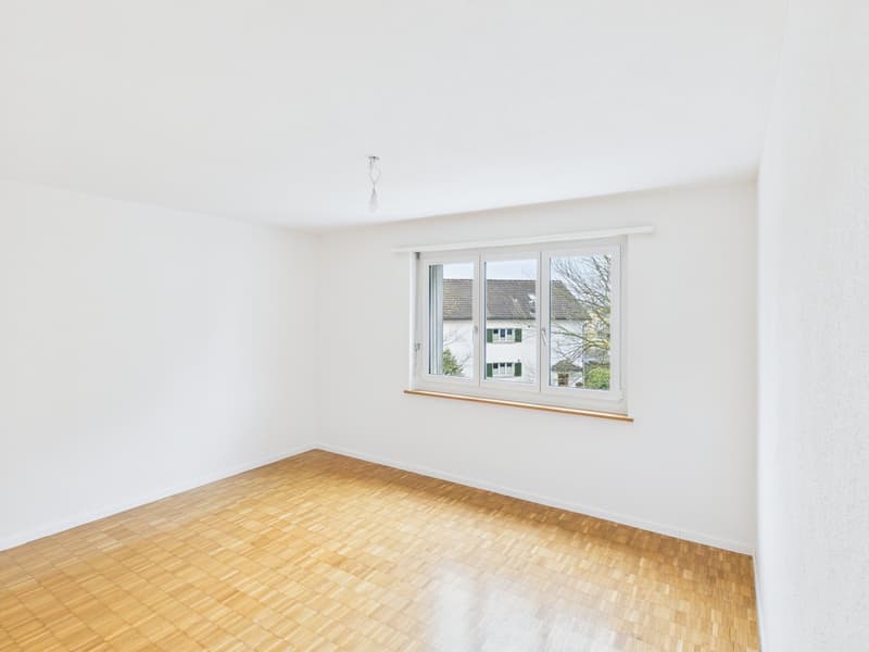 empty room, white walls, wooden floor, large window, bright