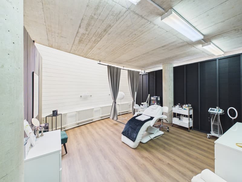 modern clean room, wooden floor, concrete ceiling, black and white walls, white medical chair, white desk, gray curtains