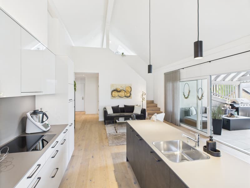 modern kitchen with white cabinets, wooden floor, stainless steel sink, black stove, large windows
