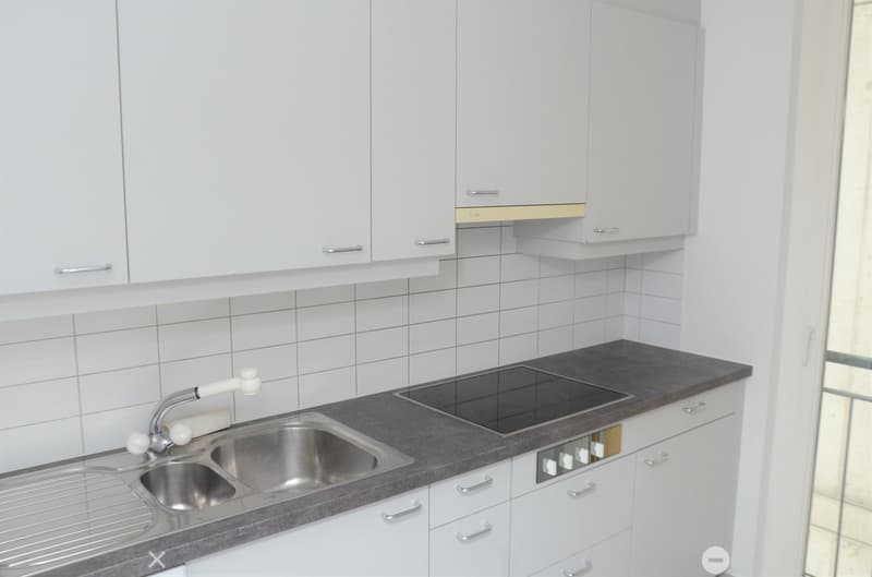 White cabinets, granite countertop, stainless steel sink, built-in oven, gas stove, and a window