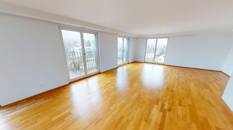 wooden floor, glass door leading to balcony, white walls, large windows, empty room